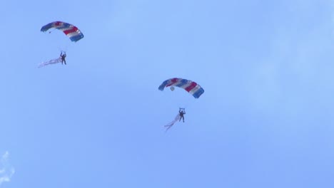 Two-people-flying-with-parachutes-at-an-air-show-in-Berlin