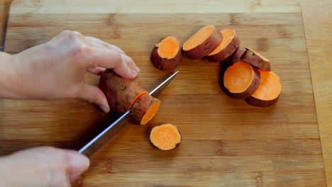 Hand-slices-sweet-potatoes
