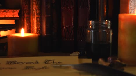 Close-up-background-of-an-ancient-library,-next-to-a-frieplace,-with-old-books,-a-feather,-old-paper,-ink,-stones,-and-candles-with-flickering-flames,-with-some-dust-flying-around