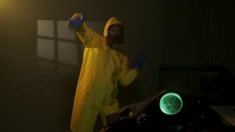 Hazmat-suit-wearing-man-dances-in-a-foggy-room
