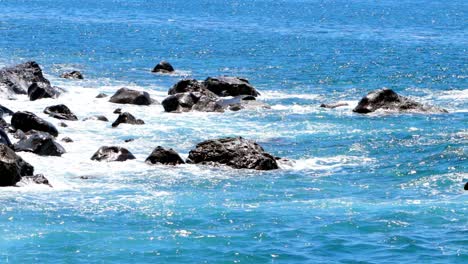 Turquoise-Seascape-scene-waves-breaking-on-volcanic-black-rocks-coastal-line-of-Madeira-Isle,-slow-motion-footage,-Atlantic-Ocean