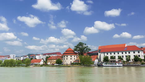 Time-lapse-of-clouds-above-small-town's-waterfront,-Maribor,-Slovenia,-Lent-district