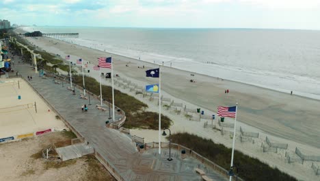 Aerial-Push-in-Shot-of-Flags-on-Boardwalk-at-Myrtle-Beach
