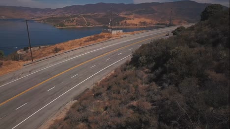 Shown-from-above,-team-of-Deputy-Sheriffs-ride-past-Castaic-Lake-in-Castaic