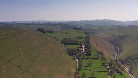 Aerial-Drone-tracking-over-valley-and-farm-fields-in-Peak-District-United-Kingdom