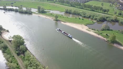 Aerial-view-of-the-big-container-or-cargo-ship-on-the-lake-or-river-in-Holland-in-4K-24-fps