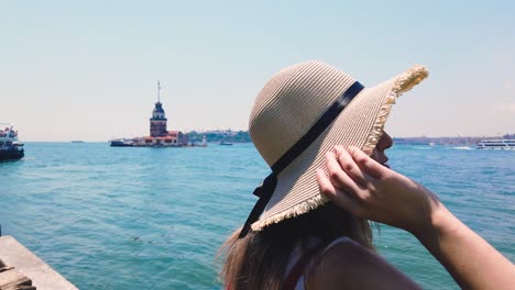 Slow-Motion:beautiful-girl-enjoys-Bosphorus-and-Maidens-Tower,a-popular-destination-in-Istanbul,Turkey