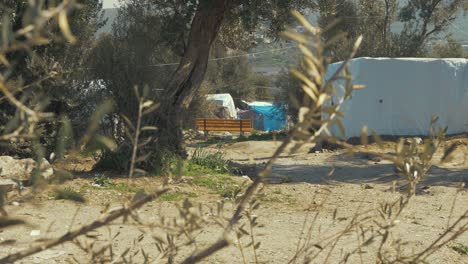 Moria-refugee-camp-'Jungle'-over-spill-bench-and-makeshift-shelters-hot-Summer