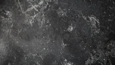 spinning-black-marble-with-gray-veining-background-texture