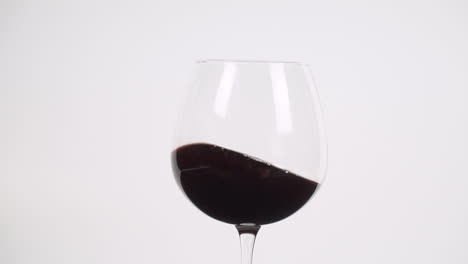 Swirling-red-wine-in-burgundy-glass