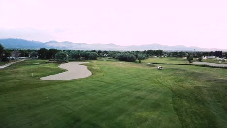 Drone-Shot-flying-over-a-fairway-on-a-luxury-green-golf-course