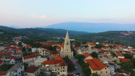 Descending-aerial-view-of-St,-Nicholas-Church-in-Selca-Croatia-Europe