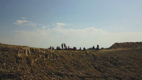 Drone-Shot-flying-away-from-a-group-of-hikers-who-are-sitting-on-a-ridgeline-of-Mount-Timpanogos