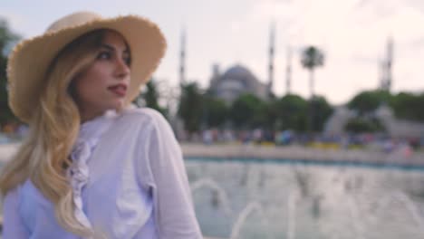 Slow-Motion:-Attractive-beautiful-girl-in-shirt-poses-in-front-of-Sultan-Ahmet-Mosque-in-Istanbul,Turkey