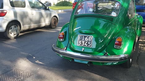 Florence,-Italy---circa-July-2019---Green-Volkwagen-Beetle-in-the-city-traffic