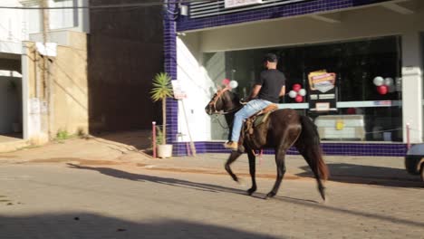 Man-on-horse-in-the-streets-of-Rio-Vermelho,-Minas-Gerais,-Brazil