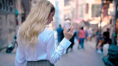 Slow-Motion:Young-beautiful-girl-eats-ice-cream-while-walking-at-narrow-street-in-Europe