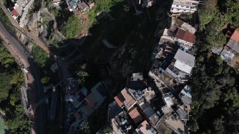 Aerial-top-down-forward-movement-showing-the-small-Rio-de-Janeiro-favela-Chacara-on-the-slopes-of-the-Two-Brothers-mountain-next-to-the-bigger-Vidigal-shanty-town