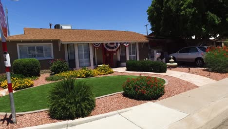 -Pan-suburban-house-in-the-US-decked-out-in-patriotic-bunting-for-the-fourth-of-July,-Phoenix,-Arizona-Concept:-patriotism,-show-your-colors,-American