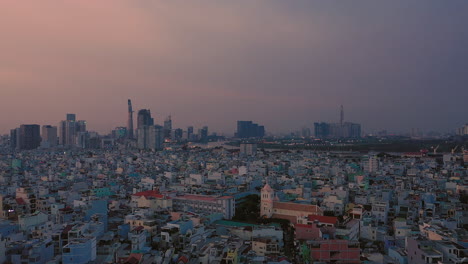 Abendliche-Enthüllungsaufnahme,-Während-Sich-Die-Kamera-über-Ein-Wohngebiet-Und-Bis-Zu-Einem-Hohen-Winkel-Bewegt-Und-Den-Fluss-Und-Die-Skyline-Der-Stadt-Ho-Chi-Minh-Stadt,-Einer-Modernen-Asiatischen-Stadt,-Sichtbar-Macht