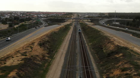 Aerial-shot-over-two-trains-passing-on-the-Joondalup-Butler-line-between-Clarkson-and-Butler-Station-in-Perth-Western-Australia