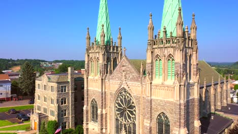 Droning-by-a-beautiful-Church-in-Hazleton,-Pennsylvania-and-revealing-the-town-in-the-background