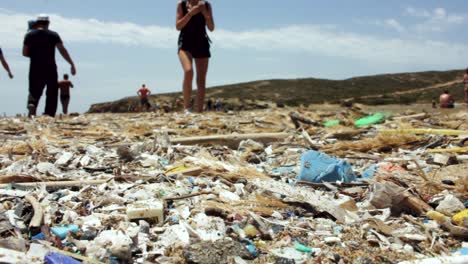 Environmental-pollution-with-plastic-trash-on-beach-and-people-ignore-it