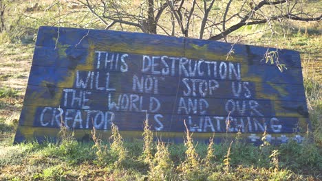 A-sign-at-a-tribute-on-Apache-holy-ground-in-Arizona-that-says-"This-Destruction-Will-Not-Stop-Us---The-World-and-Our-Creator-Is-Watching