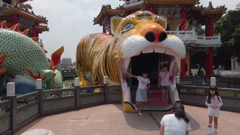 Tourists-pose-for-a-photograph-at-the-Dragon-and-Tiger-Pagodas-in-Kaohsiung,-Taiwan