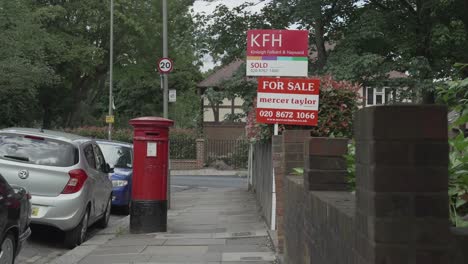 Kinleigh-Folkard---Hayward-Estate-Agent-Sold-board-in-South-London-with-a-red-Royal-Mail-Post-Box