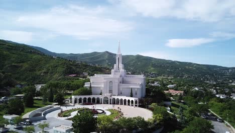 Drone-shot-smoothly-approaching-and-starting-to-circle-around-the-Bountiful-Temple-with-the-Wasatch-Mountains-seen-in-the-background