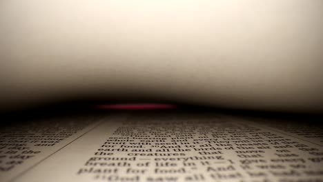 GENESIS-Slowly-pushing-lens-into-a-book,-center-view-of-the-page