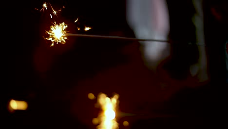 Slow-Motion-shot-of-some-people-holding-sparklers-fireworks-during-a-time-of-celebration