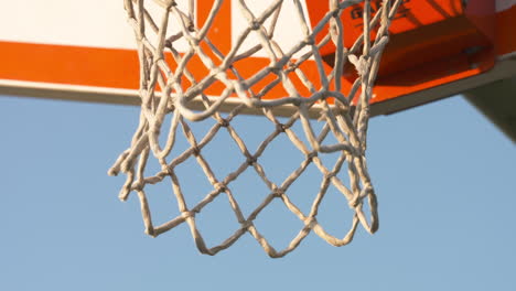 Close-up-of-a-basketball-net-against-a-blue-sky-background