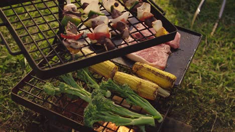 Turning-vegetables-and-meat-over-a-fire-BBQ-in-the-afternoon-glow