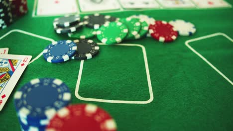 Two-Aces-Thrown-on-Green-Casino-Table---Chips-Checks-Casino-Token--Poker---Down-Shot---Slow-Motion