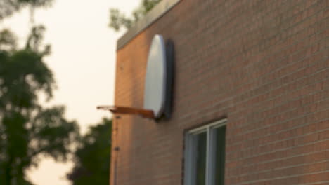 Rack-focus-on-a-basketball-hoop-hanging-on-the-red-brick-wall-of-a-school