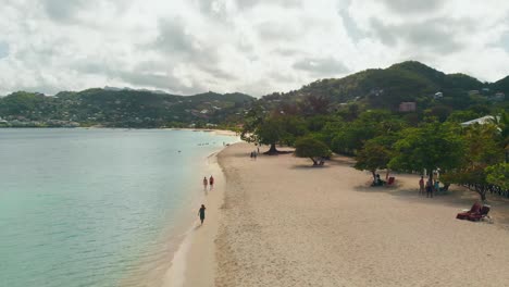Grand-Anse-Beach,-Grenada-aerial-views-with-mountains-and-cloudscape-in-the-background