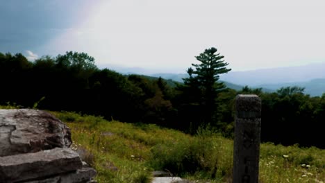 View-of-the-Shenandoah-Valley-and-a-flower-filled-meadow-as-camera-booms-up-from-behind-a-stone-wall