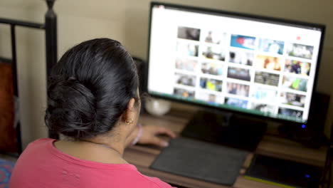 Indian-asian-caucasian-woman-working-on-desktop-pc-computer-at-home