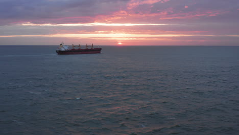 Cargo-ship-leaving-the-Westerschelde-onto-the-North-Sea-during-a-sunset