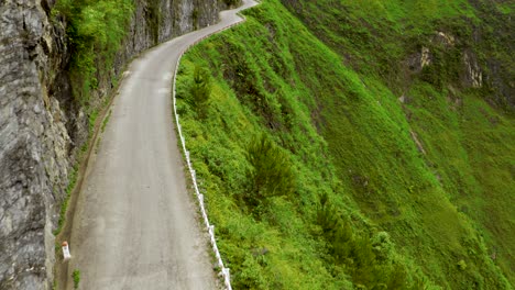 Around-the-corner-reveal-of-a-scenic-road-cut-into-the-mountains-of-the-gorgeous-Ma-Pi-Leng-Pass-in-northern-Vietnam