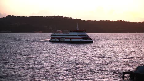 Ferry-boat-on-river-Tejo-at-sunset-with-factories-in-background