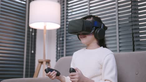 Asian-lovely-girl-playing-Virtual-Reality-VR-enjoying-video-games-cheerful-on-a-sofa-in-the-living-room-at-home