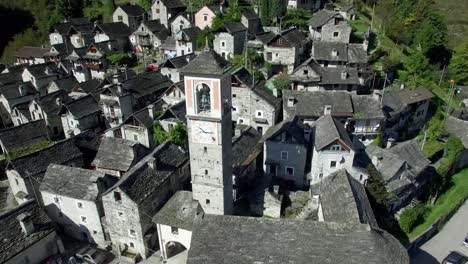 aerial-view-of-church-steeple-in-medieval-town-village-of-Corippo-in-the-swiss-mountains,-small-mountain-village-in-Ticino,-Switzerland