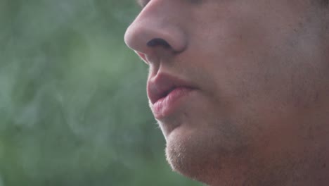Close-Up-of-Male-Model-Smoking-Vaporizer-Outside-60fps
