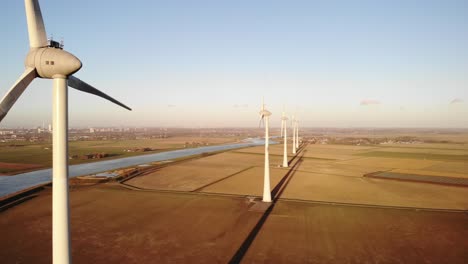 Green-and-renewable-energy-concept,-aerial-view-of-a-wind-turbine-in-a-field