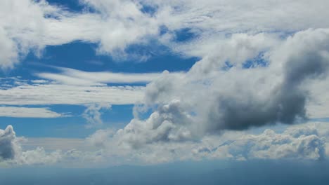 Aerial-dreamy-cloudscape,-fluffy-cumulus,-wispy-cirrus-clouds-flow-in-sky