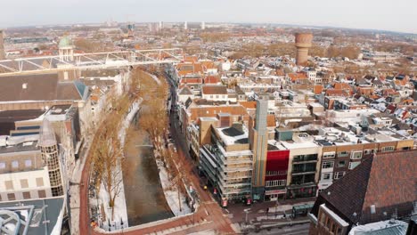 Aerial-Pedestal-Down-Tilt-Up-View-Across-Winter-Rooftops-In-Utrecht