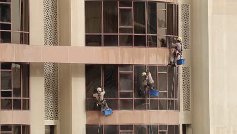 A-team-of-3-professional-glass-cleaning-staff-doing-weekly-cleaning-multi-story-building